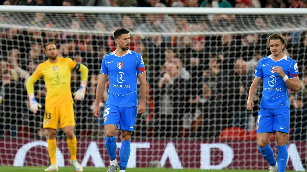 Soccer Football - UEFA Champions League - Liverpool v Atletico Madrid - Anfield, Liverpool, Britain - September 17, 2025 Atletico Madrid's Jan Oblak, Clement Lenglet and Conor Gallagher look dejected after Liverpool's Andy Robertson scores their first goal REUTERS/Peter Powell