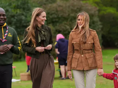 Britain's Kate, Princess of Wales, centre left, and first lady Melania Trump meet members of the Scouts' Squirrels programme in Frogmore Gardens, Windsor, England, Thursday, Sept. 18, 2025. (Yui Mok/Pool Photo via AP)