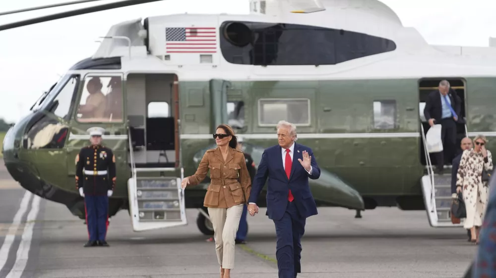 President Donald Trump and first lady Melania Trump wave after arriving on Marine One at Stansted Airport, Thursday, Sept. 18, 2025, in Stansted, England. (AP Photo/Evan Vucci)