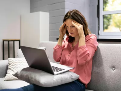 2H2GX51 Depressed Business Woman In Home Office With Headache