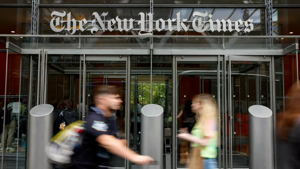 FILE PHOTO: People walk by The New York Times building in Manhattan, New York City, U.S., September 16, 2025. U.S. President Donald Trump has filed a $15 billion defamation lawsuit against the New York Times and book publisher Penguin Random House. REUTERS/Kylie Cooper/File Photo