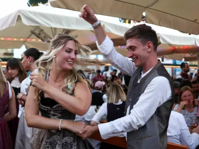 People celebrate on the day of the official opening of the 190th Oktoberfest, the world's largest beer festival in Munich, Germany, September 20, 2025. REUTERS/Maryam Majd