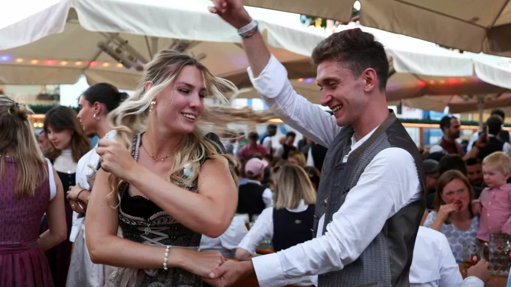 People celebrate on the day of the official opening of the 190th Oktoberfest, the world's largest beer festival in Munich, Germany, September 20, 2025. REUTERS/Maryam Majd