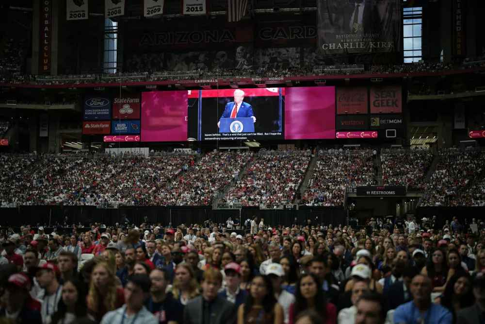 President Donald Trump, seen on a stadium screen, speaks at a memorial for conservative activist Charlie Kirk, Sunday, Sept. 21, 2025, at State Farm Stadium in Glendale, Ariz. (AP Photo/John Locher)
