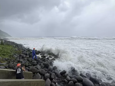 People watch as strong waves batter Basco, Batanes province, northern Philippines as Typhoon Ragasa affects the area on Monday, Sept. 22, 2025. (AP Photo/Justine Mark Pillie Fajardo)