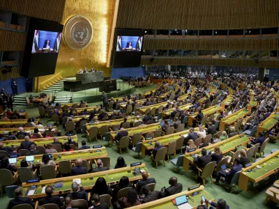 Palestinian President Mahmoud Abbas appears on a screen as he speaks virtually during a high-profile meeting at the United Nations aimed at galvanizing support for a two-state solution to the Israeli-Palestinian conflict Monday, Sept. 22, 2025, at UN headquarters. (AP Photo/Angelina Katsanis)