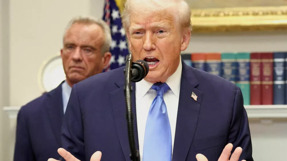FILE PHOTO: U.S. President Donald Trump, in front of U.S. Secretary of Health and Human Services Robert F. Kennedy Jr., delivers remarks linking autism to childhood vaccines and to the use of popular pain medication Tylenol for pregnant women and children, claims which are not backed by decades of science, at the White House in Washington, D.C., U.S., September 22, 2025. REUTERS/Kevin Lamarque/File Photo