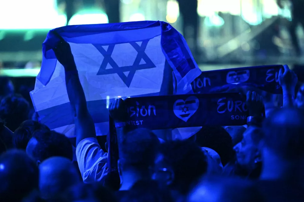 17 May 2025, Switzerland, Basel: A person holds an Israeli flag during the Grand Final of the Eurovision Song Contest 2025 in Basel. The European Broadcasting Union (EBU), which organizes Eurovision, said on Thursday that it will hold an online meeting in November to vote on participation in the 2026 contest, as debate over Israel's involvement continues to stir controversy. Photo: Heikki Saukkomaa/Lehtikuva/dpa
