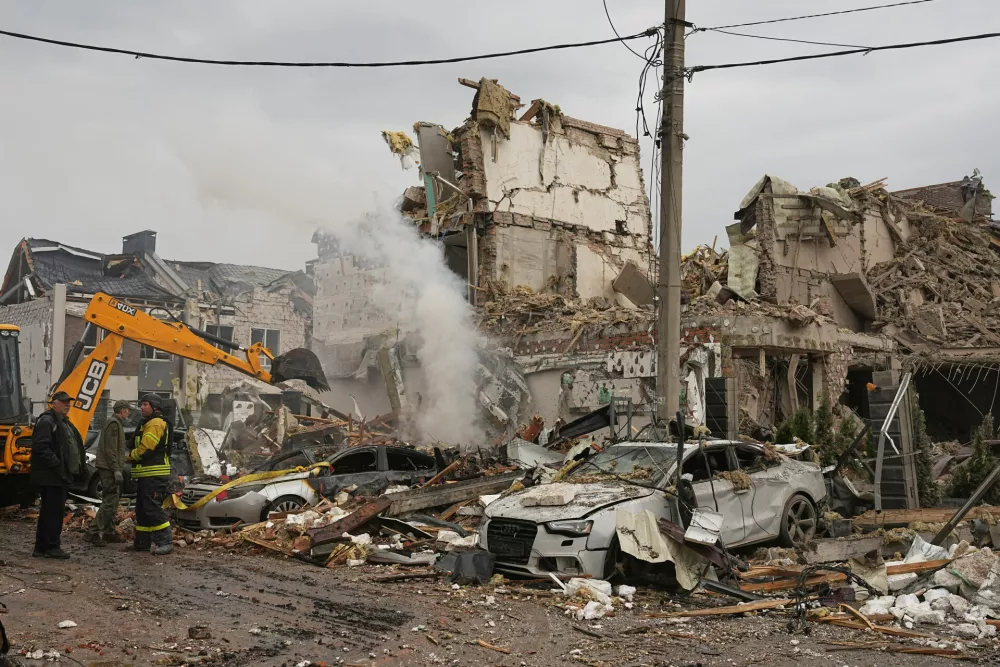 Rescuers work at the site of an apartment buildings damaged during a Russian attack in Kyiv, Ukraine, Sunday, Sept. 28, 2025. (AP Photo/Efrem Lukatsky)