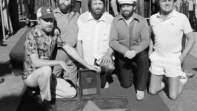 Members of The Beach Boys, from left, Mike Love, Carl Wilson, Brian Wilson, Al Jardine and Bruce Johnston, pose with their star on the Hollywood Walk of Fame, during a ceremony in Los Angeles on Dec. 30, 1980. (AP Photo/Lennox McLendon, File)