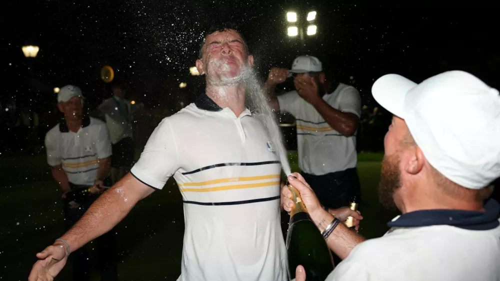 Golf - The 2025 Ryder Cup - Bethpage Black Golf Course, Farmingdale, New York, United States - September 28, 2025 Team Europe's Shane Lowry and Rory McIlroy spray champagne as they celebrate winning the Ryder Cup REUTERS/Paul Childs