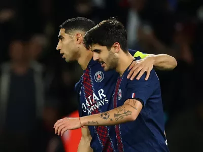 Soccer Football - Ligue 1 - Paris St Germain v AJ Auxerre - Parc des Princes, Paris, France - September 27, 2025 Paris St Germain's Lucas Beraldo celebrates scoring their second goal with Achraf Hakimi REUTERS/Sarah Meyssonnier