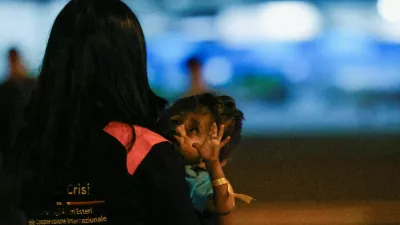 A person holds a Palestinian child who was evacuated from Gaza via a humanitarian airlift and arrived in Italy with relatives for medical treatment, at Ciampino Military Airport in Ciampino, Italy September 29, 2025. REUTERS/Francesco Fotia