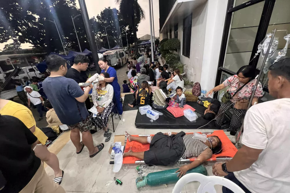 Patients wait outside the Cebu Provincial Hospital Bogo City after a strong earthquake struck in Bogo city, Cebu province, central Philippines, Wednesday Oct. 1, 2025. (AP Photo)