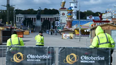 Security stands in front of an Theresienwiese entrance as the Oktoberfest beer festival will remain shut until at least 5 pm (1500 GMT) today, after police said they discovered explosives in a residential building in the north of the city that caught fire and left one person dead in Munich, Germany, October 1, 2025.  REUTERS/Fariha Farooqui