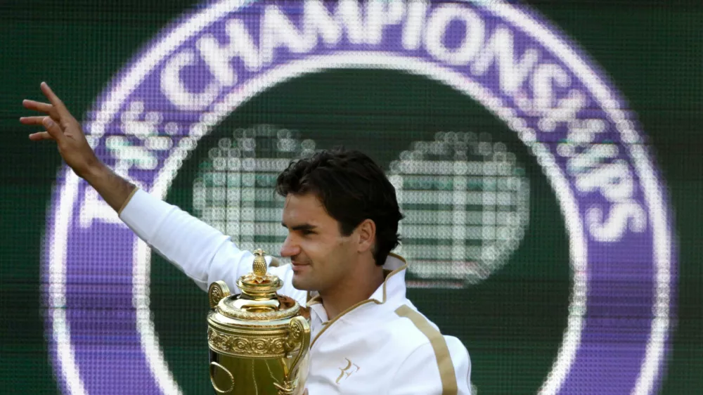 FILE - Roger Federer of Switzerland holds the trophy after defeating Andy Roddick of U.S. in their men's final match on the Centre Court at Wimbledon, July 5, 2009. (AP Photo/Anja Niedringhaus, file)