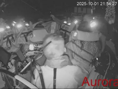 A screengrab from a live video footage shows crew members sitting aboard the Gaza-bound Aurora vessel, part of the Global Sumud Flotilla, October 1, 2025. Global Sumud Flotilla/Handout via REUTERS  THIS IMAGE HAS BEEN SUPPLIED BY A THIRD PARTY. MANDATORY CREDIT. NO RESALES. NO ARCHIVES.