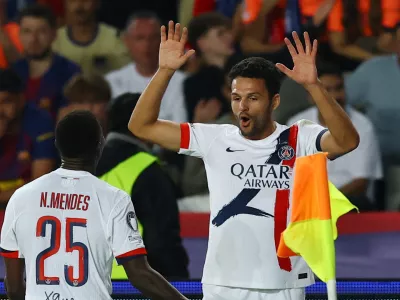 Soccer Football - UEFA Champions League - FC Barcelona v Paris St Germain - Estadi Olimpic Lluis Companys, Barcelona, Spain - October 1, 2025 Paris St Germain's Goncalo Ramos celebrates scoring their second goal with Nuno Mendes REUTERS/Albert Gea