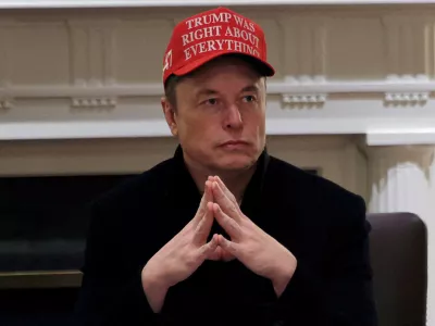 FILE PHOTO: Tesla CEO Elon Musk wears a 'Trump Was Right About Everything!' hat while attending a cabinet meeting at the White House, in Washington, D.C., U.S., March 24, 2025. REUTERS/Carlos Barria/File Photo
