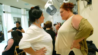 Giovanna Guidoni (R) and Stefania Ugolini chat as they wait for make-up before attending the 16th edition of Italy's Miss Cicciona contest (Italy's Miss Chubby) in Forcoli, central Italy, July 24, 2004. The chubby contest takes place every year in this Tuscan town near Pisa, gathering fat people from all over Italy. According to the main rule, women participants have to weigh at least 100 kg while men at least 150 kg. This 2004 title of Miss Chubby was won by 190Kg weight Giovanna Guidoni. Picture taken July 24. REUTERS/Alessia Pierdomenico AMP/DBP