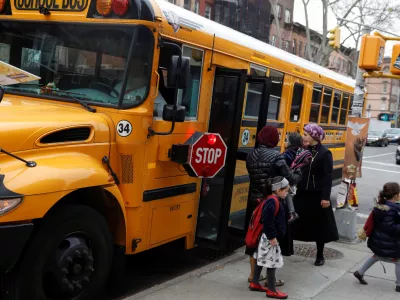 Orthodox Jewish children get off a Yeshiva school bus, as New York City Mayor Bill de Blasio declared a public health emergency in parts of Brooklyn in response to a measles outbreak, in the Williamsburg neighborhood of Brooklyn in New York City, U.S., April 9, 2019. REUTERS/Shannon Stapleton