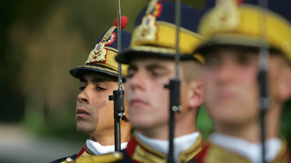 Romanian soldiers stand to attention during a ceremony to mark Romania's Army Day in Bucharest, October 25, 2005. Romania, which became a NATO member in 2004 along with neighbour Bulgaria, must modernise its armed forces and create a flexible, smaller and professional army up to the alliance's standards in the coming years Romanian Defence Minister Teodor Atanasiu said.  REUTERS/Bogdan Cristel