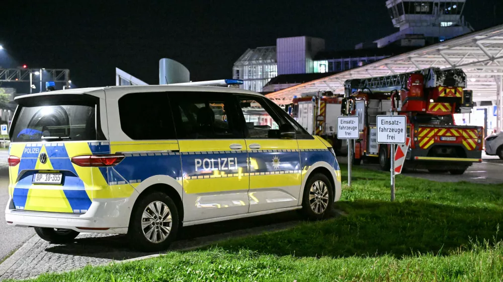 Police and fire department are on duty after drone sightings and flight cancellations at Munich Airport, Friday, Oct.3, 2025. (Jason Tschepljakow/dpa via AP)