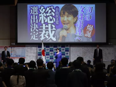 Newly elected leader of the Liberal Democratic Party (LDP) Sanae Takaichi, center, speaks during a gathering afte the LDP's leadership election in Tokyo Saturday, Oct. 4, 2025. The words read " Toward the first female prime minister. Selected as the LDP's leader. " (Haruna Furuhashi/Kyodo News via AP)