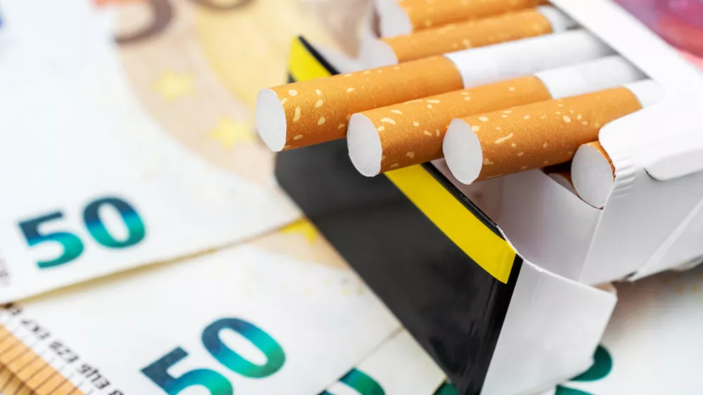 Pack of cigarettes on the euro bills. Close up.