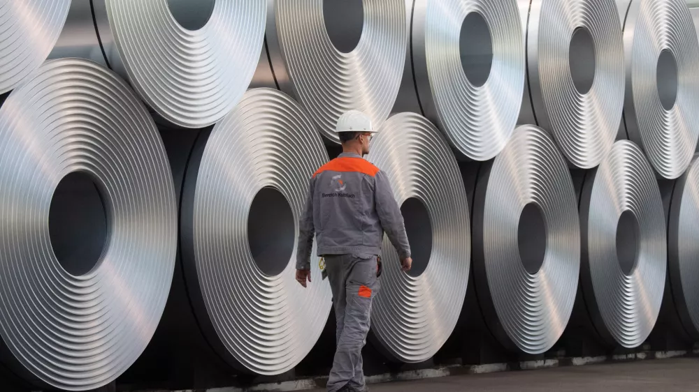 FILED - 12 July 2020, Lower Saxony, Salzgitter: An employee walks along coiled steel at Salzgitter AG. US&nbsp;President Donald Trump's announcement that he is planning to impose 25% tariffs&nbsp;on steel and aluminium imports is hitting the EU&nbsp;steel sector at the worst possible time, a German industry association said on&nbsp;Monday. Photo: Julian Stratenschulte/dpa