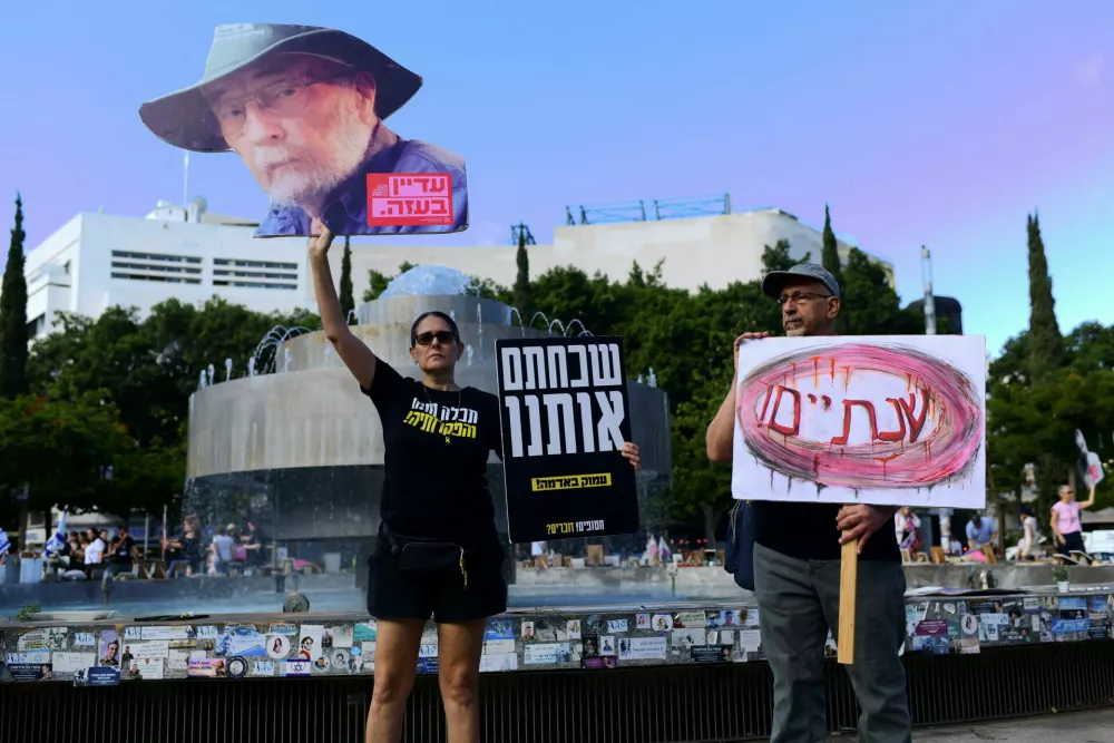 A woman holds up a poster of Israeli hostage Arie Zalmanowicz, who died in captivity and whose body is still being held in Gaza, on the two-year anniversary of the deadly October 7, 2023 attack on Israel by Hamas from Gaza, in Tel Aviv, Israel, October 7, 2025. Other signs read "two years" and "you forgot us". REUTERS/Tomer Neuberg