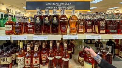 FILE PHOTO: A worker places bottles of American whiskey into a shopping cart to fill an order for a restaurant, at a Liquor Control Board of Ontario (LCBO) store in Hamilton, Ontario, Canada February 2, 2025. REUTERS/Carlos Osorio/File Photo