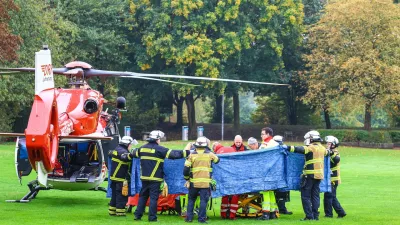 07 October 2025, North Rhine-Westphalia, Herdecke: Emergency services stand next to a rescue helicopter after the newly elected mayor of Herdecke, Iris Stalzer, was found critically injured in her apartment. Iris Stalzer, from the centre-left Social Democratic Party, suffered multiple stab wounds, security sources told dpa on Tuesday. Photo: Alex Talash/dpa