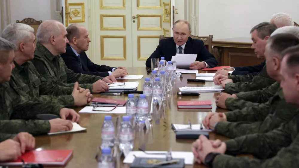 Russian President Vladimir Putin, center, speaks to the leadership of the Russian Ministry of Defense and the General Staff, commanders of troop groups in the special military operation zone in St. Petersburg, Russia, Tuesday, Oct. 7, 2025. (Mikhail Metzel, Sputnik, Kremlin Pool Photo via AP)