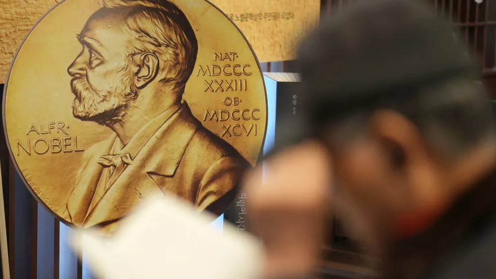FILE - A visitor reads a book written by South Korean author Han Kang, this year's winner of the Nobel Prize in Literature, at a special section of a bookstore in Seoul, South Korea, Tuesday, Dec. 10, 2024. (AP Photo/Lee Jin-man, File)