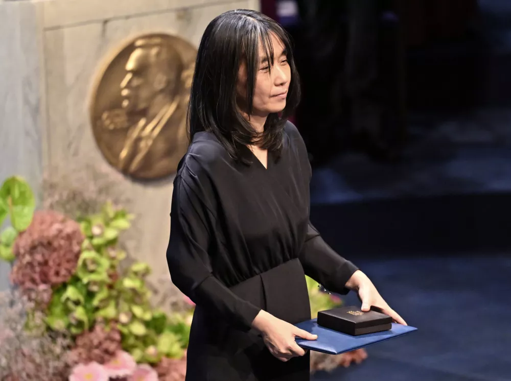 Nobel laureate in literature Han Kang holds her award during the Nobel Prize ceremony in Stockholm, Sweden, Tuesday, Dec. 10, 2024. (Jonas Ekstroemer/TT News Agency via AP)