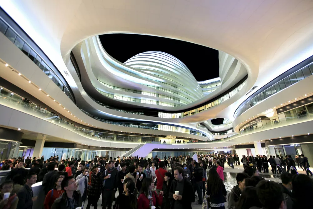People visit the newly opened Galaxy Soho building, designed by Iraqi-British architect Zaha Hadid, in Beijing October 27, 2012. REUTERS/Jason Lee/Files