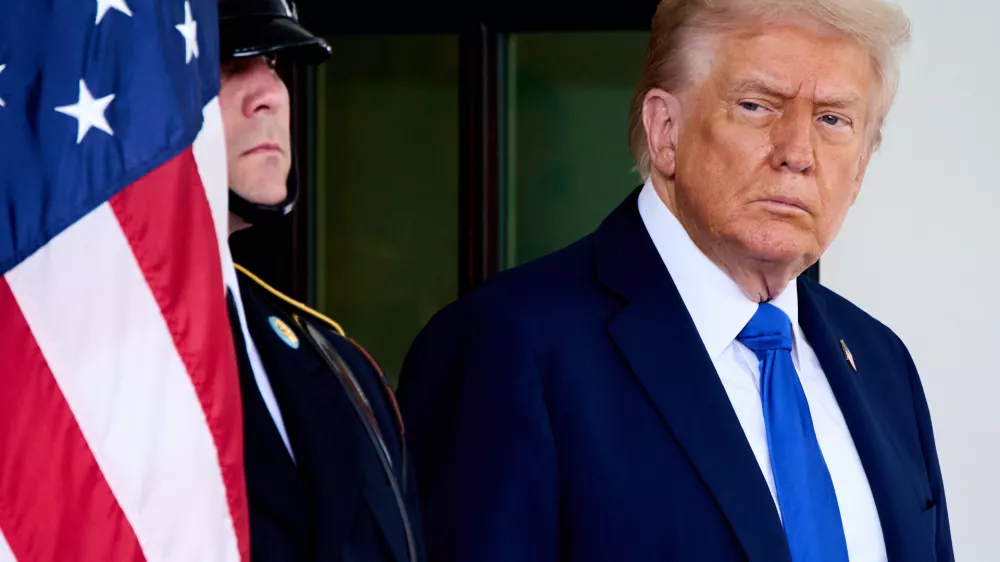 President Donald Trump waits to greet Canada's Prime Minister Mark Carney, as Carney arrives at the White House, Tuesday, Oct. 7, 2025, in Washington. (AP Photo/Jacquelyn Martin)