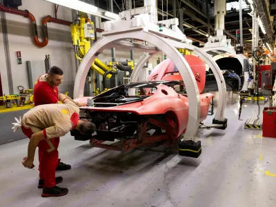 FILE PHOTO: Ferrari workers inspect a supercar chassis inside the company's factory in Maranello, Italy, October 2, 2025. REUTERS/Remo Casilli/File Photo