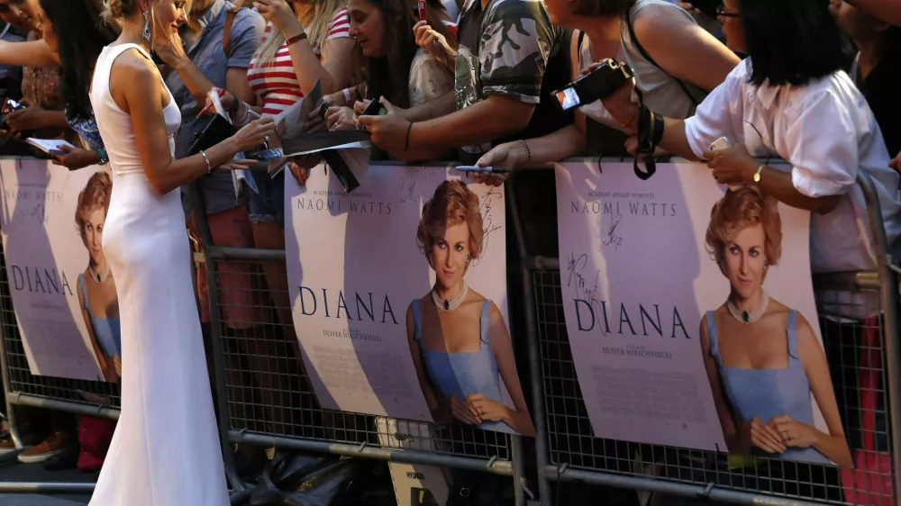 Cast member Naomi Watts of Australia, who plays the title role, signs autographs before the world premiere of "Diana" at Leicester Square in London September 5, 2013. "Diana" a biopic of the late, famed British princess, is due to open in theatres later this month.  REUTERS/Luke MacGregor (BRITAIN - Tags: ENTERTAINMENT)