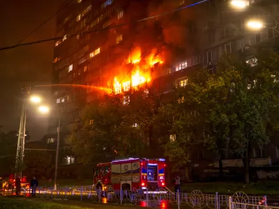 Emergency services personnel work to extinguish a fire following a Russian attack in Kyiv, Ukraine, Friday, Oct. 10, 2025. (AP Photo/Dan Bashakov)