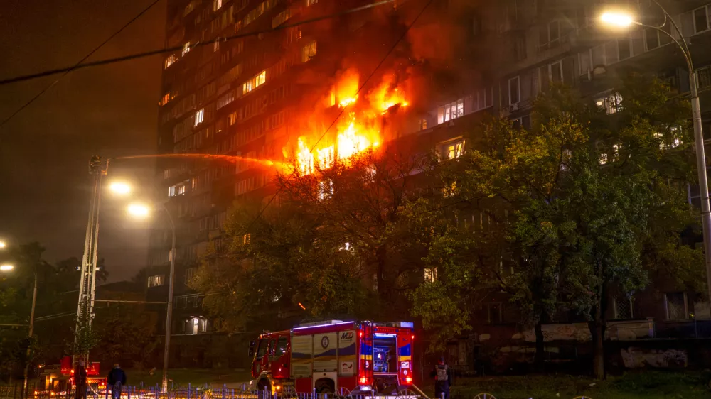 Emergency services personnel work to extinguish a fire following a Russian attack in Kyiv, Ukraine, Friday, Oct. 10, 2025. (AP Photo/Dan Bashakov)
