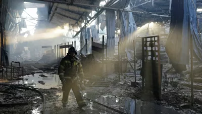 A firefighter works inside the burned-out Sigma shopping mall following yesterday evening's Ukrainian military strike, in the course of Ukraine-Russia conflict in Donetsk, a Russian-controlled city of Ukraine, October 12, 2025. REUTERS/Alexander Ermochenko