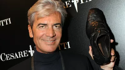 Italian shoe designer Cesare Paciotti holds a shoe he made for English football player David Beckham on January 19, 2009 during the Men's fashion week in Milan.,Image: 29110447, License: Rights-managed, Restrictions: TO GO WITH AFP STORY BY KATIA DOLMADJIAN, Model Release: no