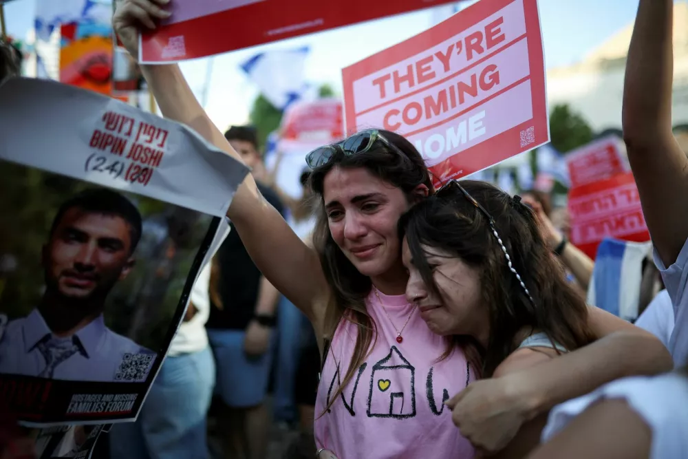 Women react at "Hostages Square" on the day Hamas releases hostages, who have been held in Gaza since the deadly October 7, 2023 attack by Hamas, as part of a prisoner-hostage swap and a ceasefire deal between Israel and Hamas, in Tel Aviv, Israel, October 13, 2025. REUTERS/Shir Torem