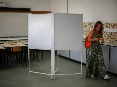 A voter folds a ballot at a polling station during the local election in Lisbon, Portugal, October 12, 2025. REUTERS/Pedro Nunes