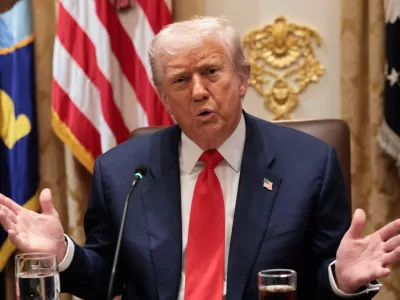 U.S. President Donald Trump gestures as he speaks during lunch with Argentina's President Javier Milei (not pictured) in the Cabinet Room at the White House in Washington, D.C., U.S., October 14, 2025. REUTERS/Jonathan Ernst