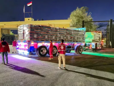 FILE PHOTO: Trucks carrying aid bound for Gaza cross the border crossing between Egypt and the Gaza Strip, after a ceasefire between Israel and Hamas in Gaza went into effect, in Rafah, Egypt, October 12, 2025. REUTERS/Stringer/File Photo