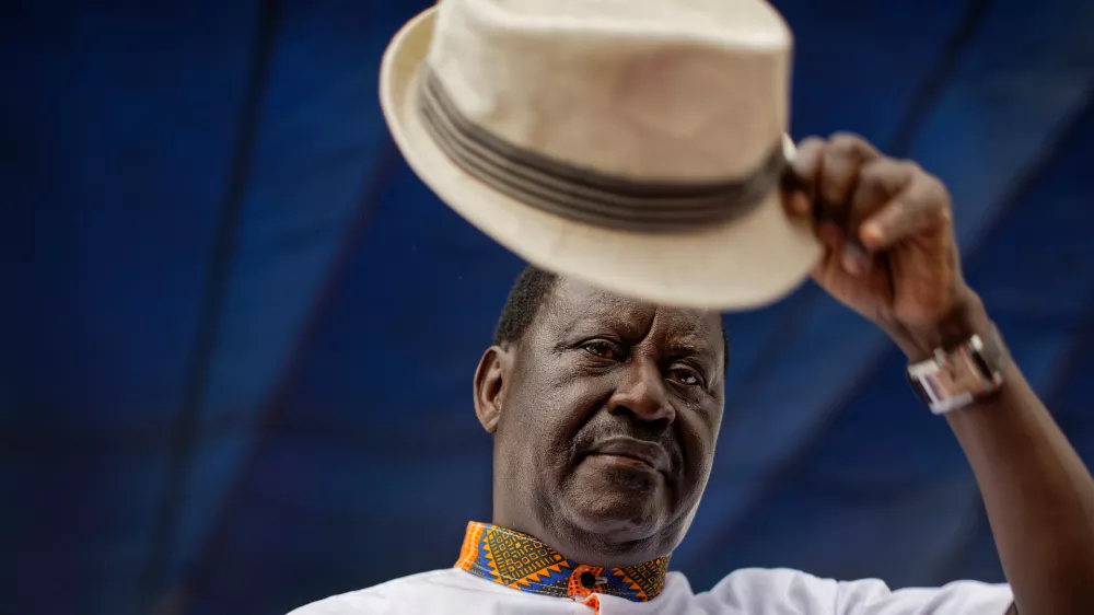 Kenyan opposition leader Raila Odinga lifts his hat to thousands of supporters gathered at a rally in the Shauri Moyo area of Nairobi, Kenya, Wednesday, Oct. 18, 2017. (AP Photo/Ben Curtis)