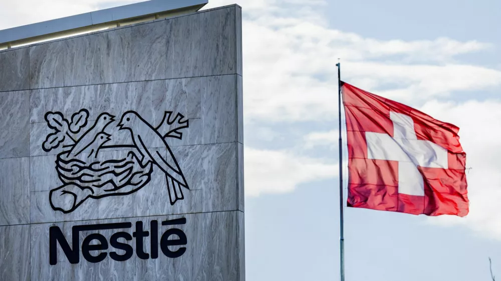 FILE PHOTO: A Swiss flag flutters on the headquarters of Nestle in Vevey, Switzerland, November 25, 2024. REUTERS/Denis Balibouse/File Photo